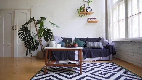 A beautiful carpet, a small table with magazines, a cozy sofa against the white Stock Footage 114566017