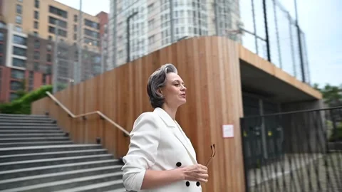 Beautiful caucasian elderly gray-haired business woman takes off her glasses Video stock 246823325