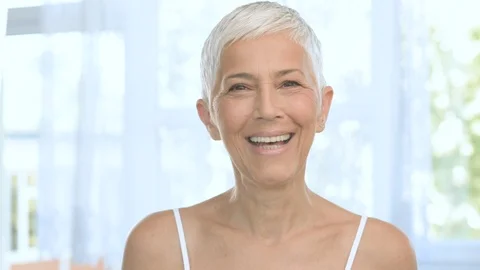 Beautiful Caucasian senior woman smiling and showing her white healthy teeth. Stock Footage