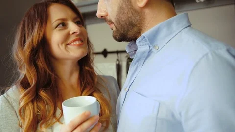 Beautiful caucasian young woman holding cup of coffee in hand, standing in Stock Footage