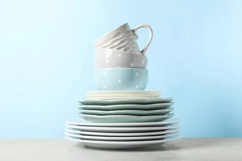 Beautiful ceramic dishware and cup on light grey table Stock Photos