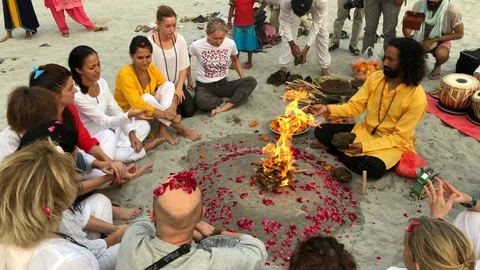 Beautiful ceremony by the fire at sunset on the beach in the holy city Stock-Footage 120327232