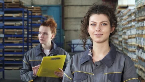 Beautiful cheerful female factory worker smiling to the camera Stock Footage