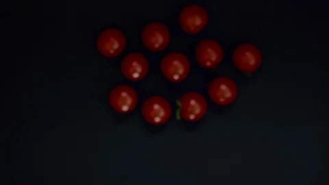 Beautiful cherry tomatoes thrown into the air. 4K slow motion video Stock Footage 111691499