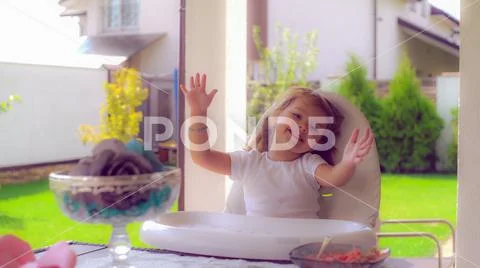 Beautiful child dance and sing at lunchtime outdoors Stock Photos