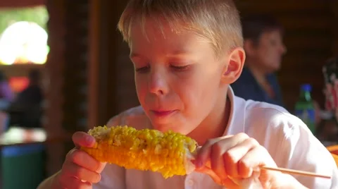 The beautiful child eats boiled corn 스톡 동영상 67755401