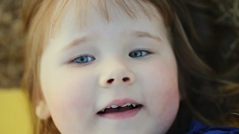 Beautiful child looking at the camera and smiling Stock Footage 122620236