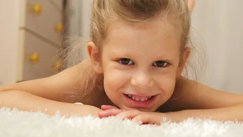 Beautiful child lying on the floor Stock Footage 94470872