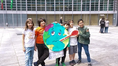 Beautiful children protesting with ill Earth picket sign, Friday for future day Stock Footage