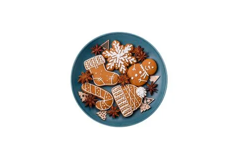 Beautiful Christmas gingerbread cookies of different colors on a ceramic plat Stock Photos