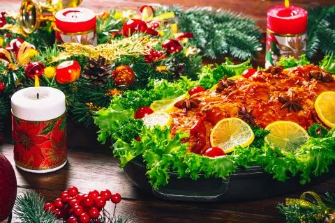 Beautiful Christmas table dinner time with roasted meats, candles and New Yea Stock Photos