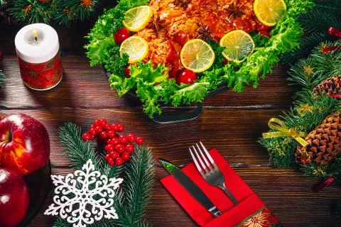 Beautiful Christmas table dinner time with roasted meats, candles and New Yea Stock Photos
