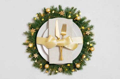 Beautiful Christmas table setting with gold cutlery and decorations. Stock Photos