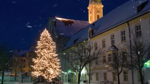 Beautiful christmas tree in front of church at blue hour with snow falling Stock Footage 162812623