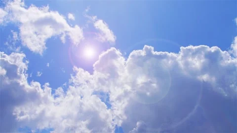 A beautiful clear blue sky features fluffy white clouds (timelaps) Stock Footage 325488091