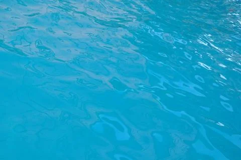 Beautiful clear pool water reflecting in the sun background Stock Photos