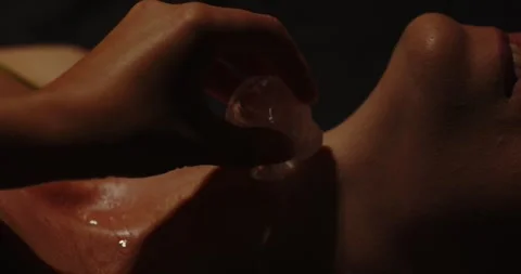 Beautiful close up of ice cube being rubbed on the body of an attractive 스톡 동영상 279613264