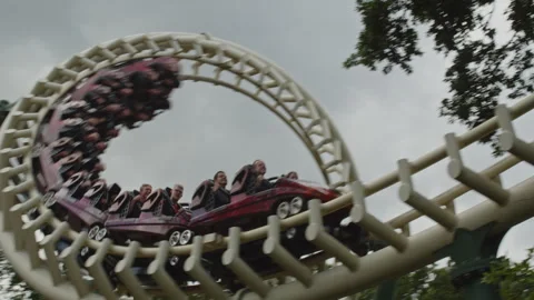 Beautiful close up of a rollercoaster going through a spiral and rushing by on Video stock 337745687
