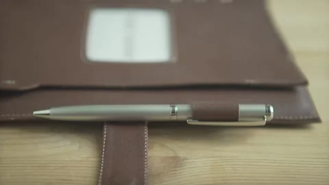 Beautiful close up shot of light brown leather note pad bullet journal book with Stock Footage 137538607