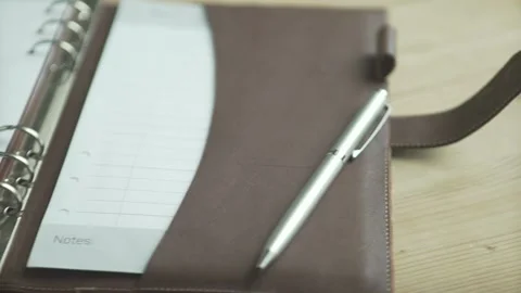 Beautiful close up shot open elegant light brown leather case daily planner note Stock Footage 137539056