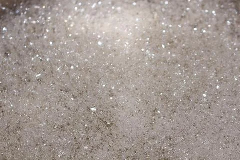 A beautiful close up texture of light brown sea foam with tiny bubbles Stock Photos