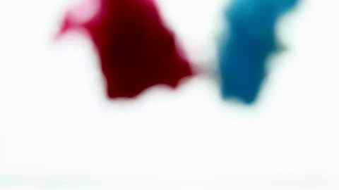 Beautiful close up view of two merging colors. Merging red and blue. Stock Footage 122252132