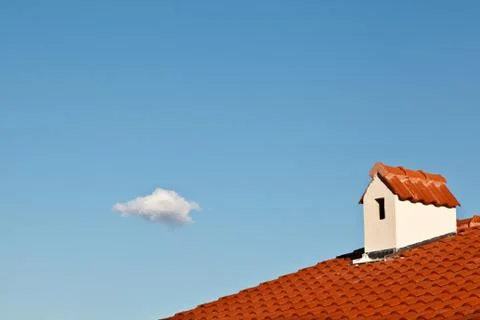 Beautiful cloud and dormer window with red tiled roof Stock Photos