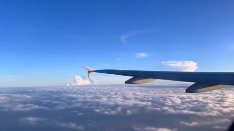 Beautiful cloud and wing of airplane from window with a nice blue sky Stock Footage 338014031