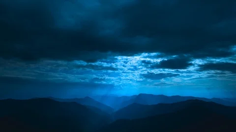 The beautiful cloud flow above mountains on a moonlight background. time lapse Stock Footage 112777511