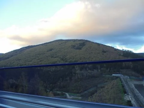 Beautiful cloud over forest covered hill in Beskydy. Broadleaf autumn forest Stock Photos