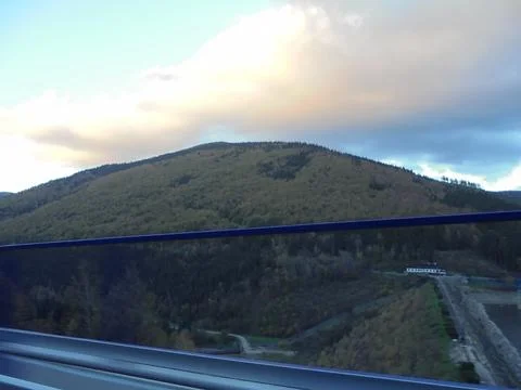 Beautiful cloud over forest covered hill in Beskydy. Broadleaf autumn forest Stock Photos