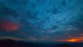 The beautiful cloud stream with a sunset above mountains. time lapse 4k or 4k+ Resolution
