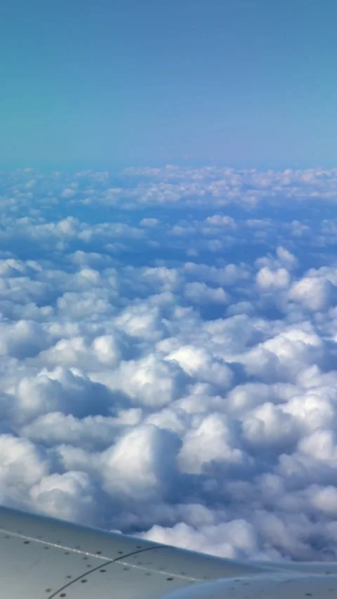 Beautiful clouds from above, as seen through airplane window. Stock Footage 317332245