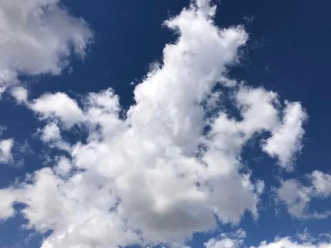 Beautiful clouds are moving against the blue sky Stock Photos
