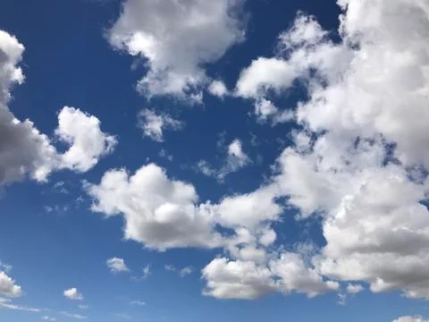 Beautiful clouds are moving against the blue sky Stock Photos