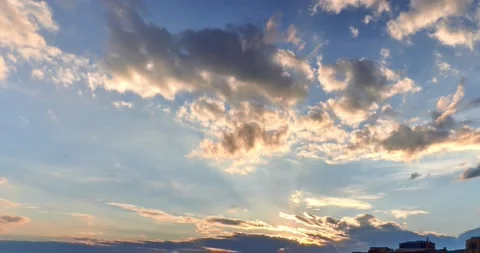 Beautiful clouds are passing at sunset in time lapse clip Stock Footage 131399338