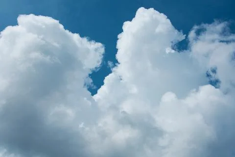 Beautiful clouds on a background of a dark blue sky. Natural background. Stock Photos