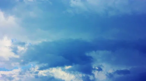 Beautiful clouds floating across a blue sky Stock Footage 40013319