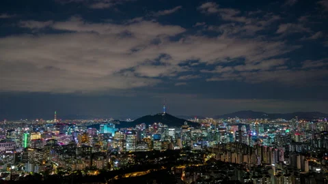 Beautiful clouds flow through Seoul city skyline aerial view  night Stock Footage 162603934