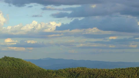 Beautiful clouds fly over the mountain at sunset Stock Footage 162951426