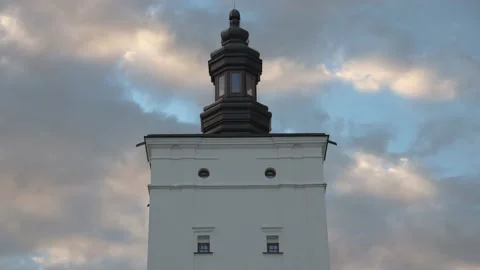 Beautiful clouds flying behind old tower. Time-lapse.4K Stock Footage 135194040