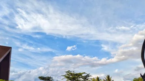 Beautiful clouds form under a clear sky Stock Photos