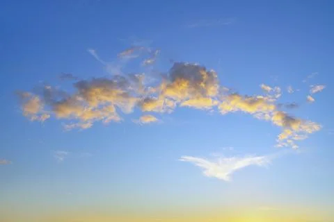 Beautiful clouds illuminated by the setting sun Stock Photos