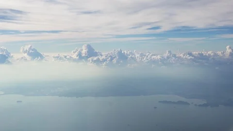 Beautiful clouds illuminated by soft sunlight floating above land  Stock Footage 89825128
