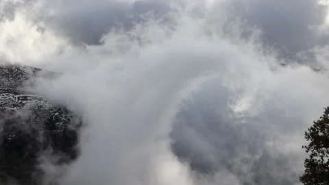 Beautiful clouds moving over a snowy mountain timelapse Stock Footage 130457073