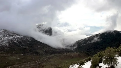 Beautiful clouds moving over a snowy mountain timelapse Stock Footage 130459819