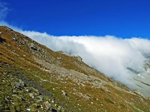 Beautiful clouds over the Alpine mountain peaks in the river Rhine valley Stock Photos