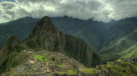Beautiful clouds over breathtaking Machu Picchu as people move through Ruins Video stock 60688520