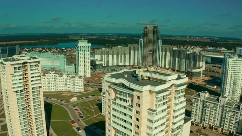 Beautiful clouds over the city in the evening. A city with multi-storey Видео 142374590