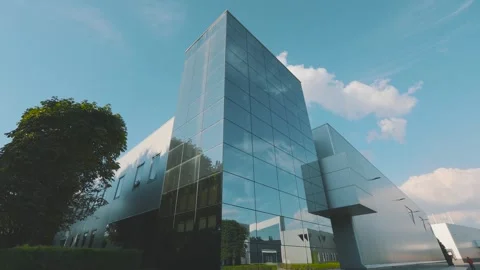 Beautiful clouds over modern office building. Exterior of a modern office Stock Footage 309528306